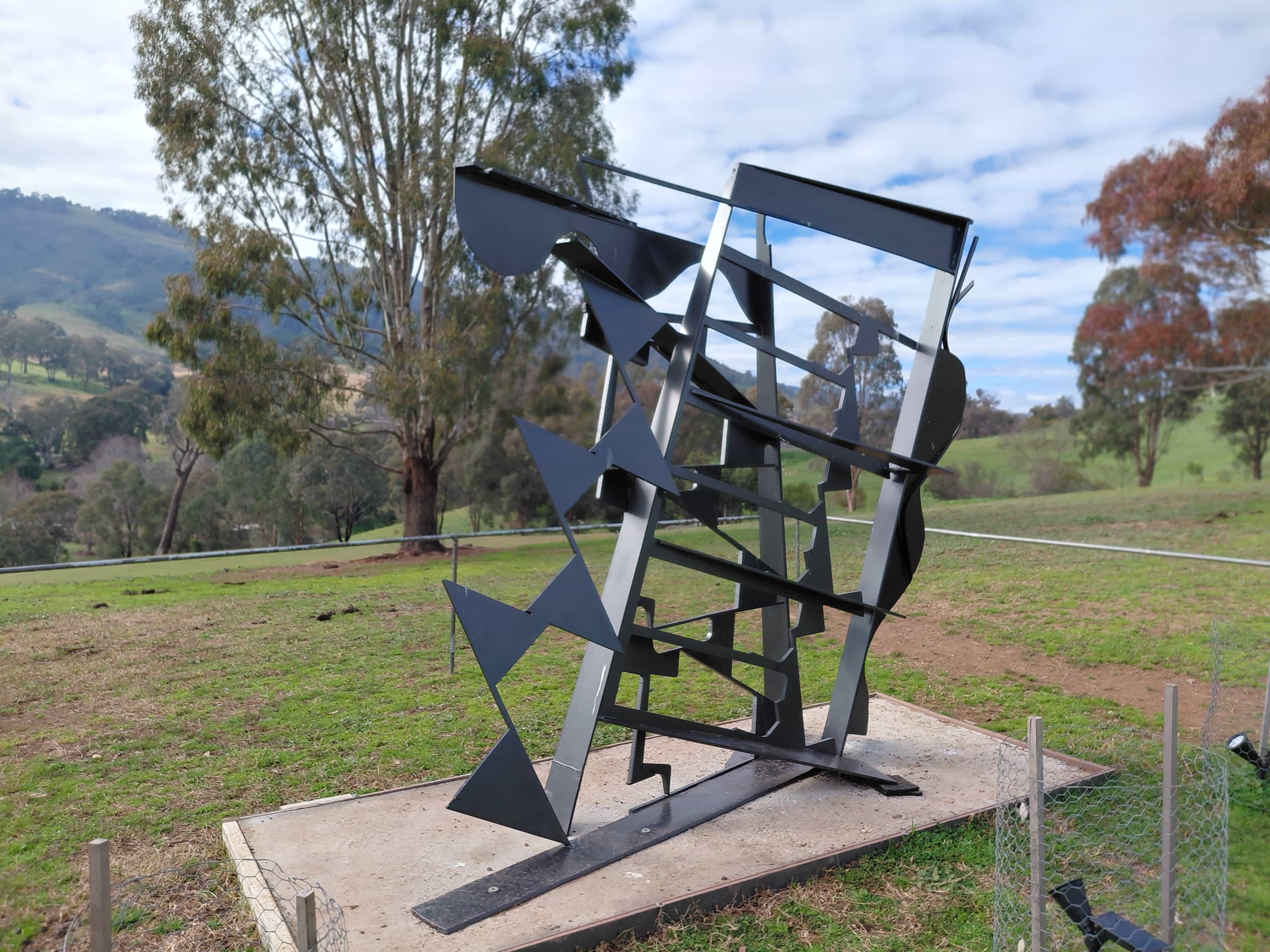 Abstract steel sculpture by Australian sculptor Michael Le Grand, overlooking the valley at Elm Cottage
